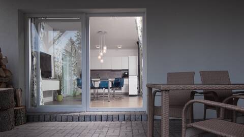 View from the terrace to the dining room of the Filip house – interconnected outdoor and indoor space